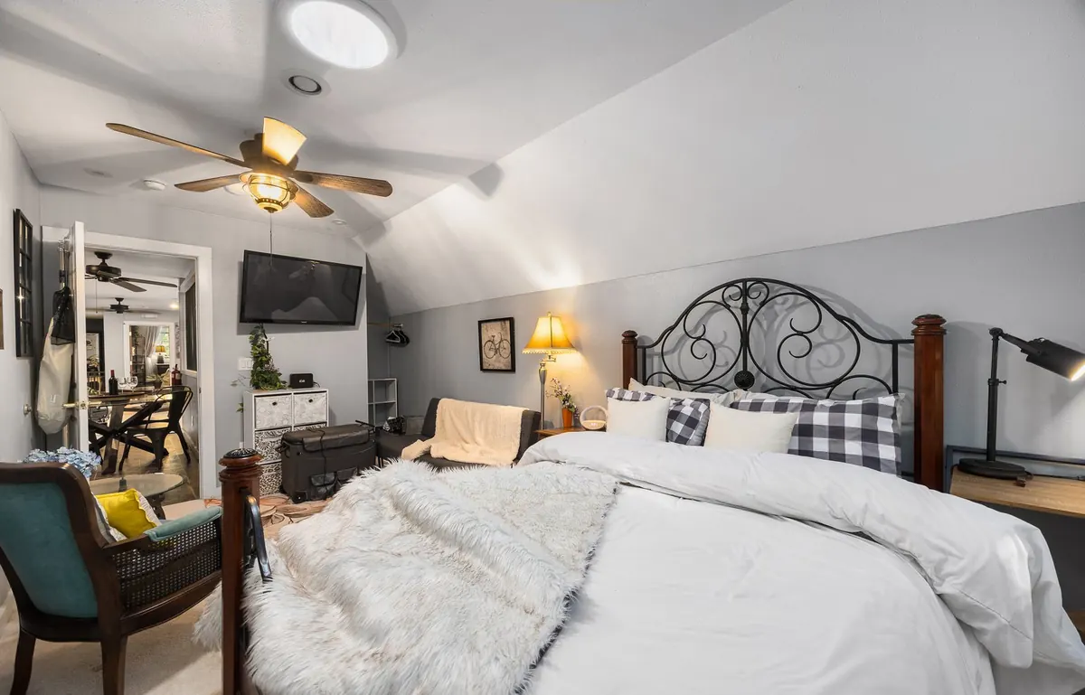 The Baker suite at The Grayson, an iron bed under a vaulted ceiling
