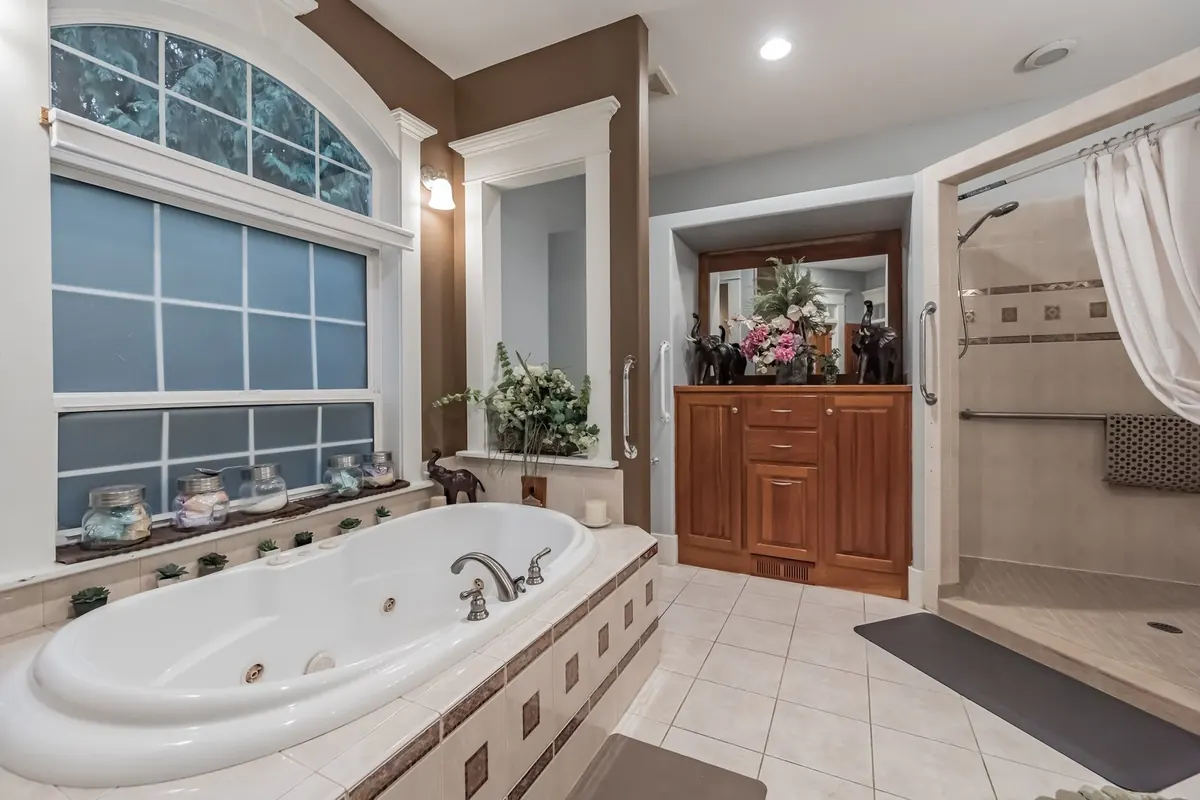 The second ADA bathroom at The Grayson, a jetted tub and walk-in shower