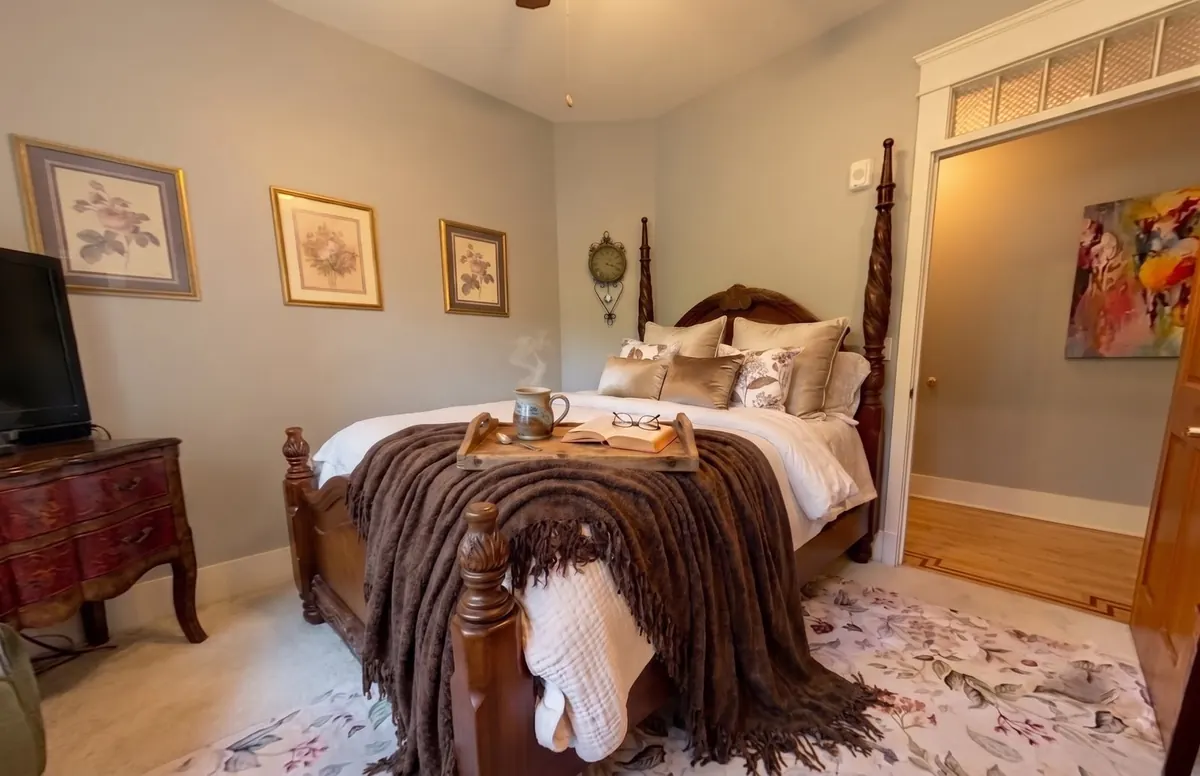 A breakfast tray on the bed in the Pike suite at The Grayson